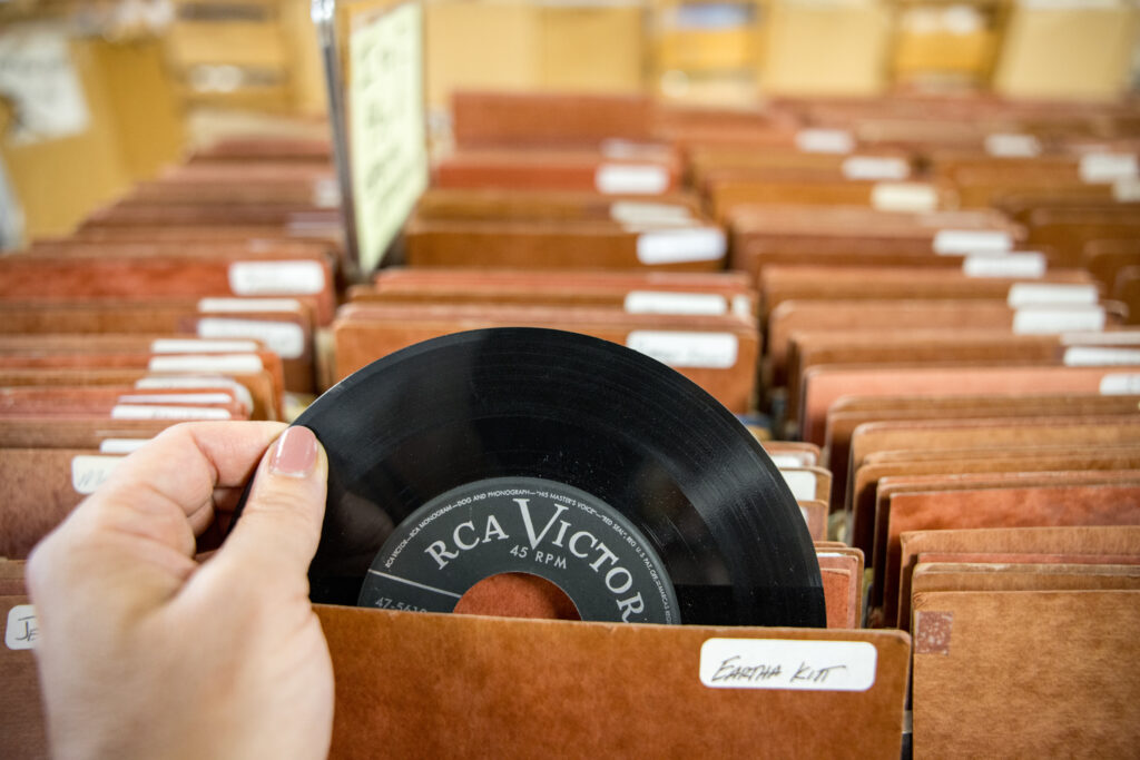 Person holding a record at a record shop in wallingford